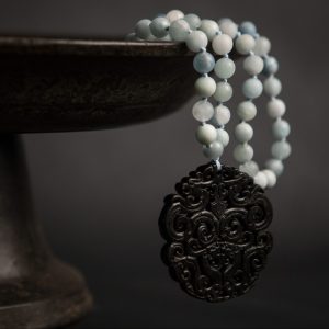 Jade vintage disc pendant on aquamarine flapper